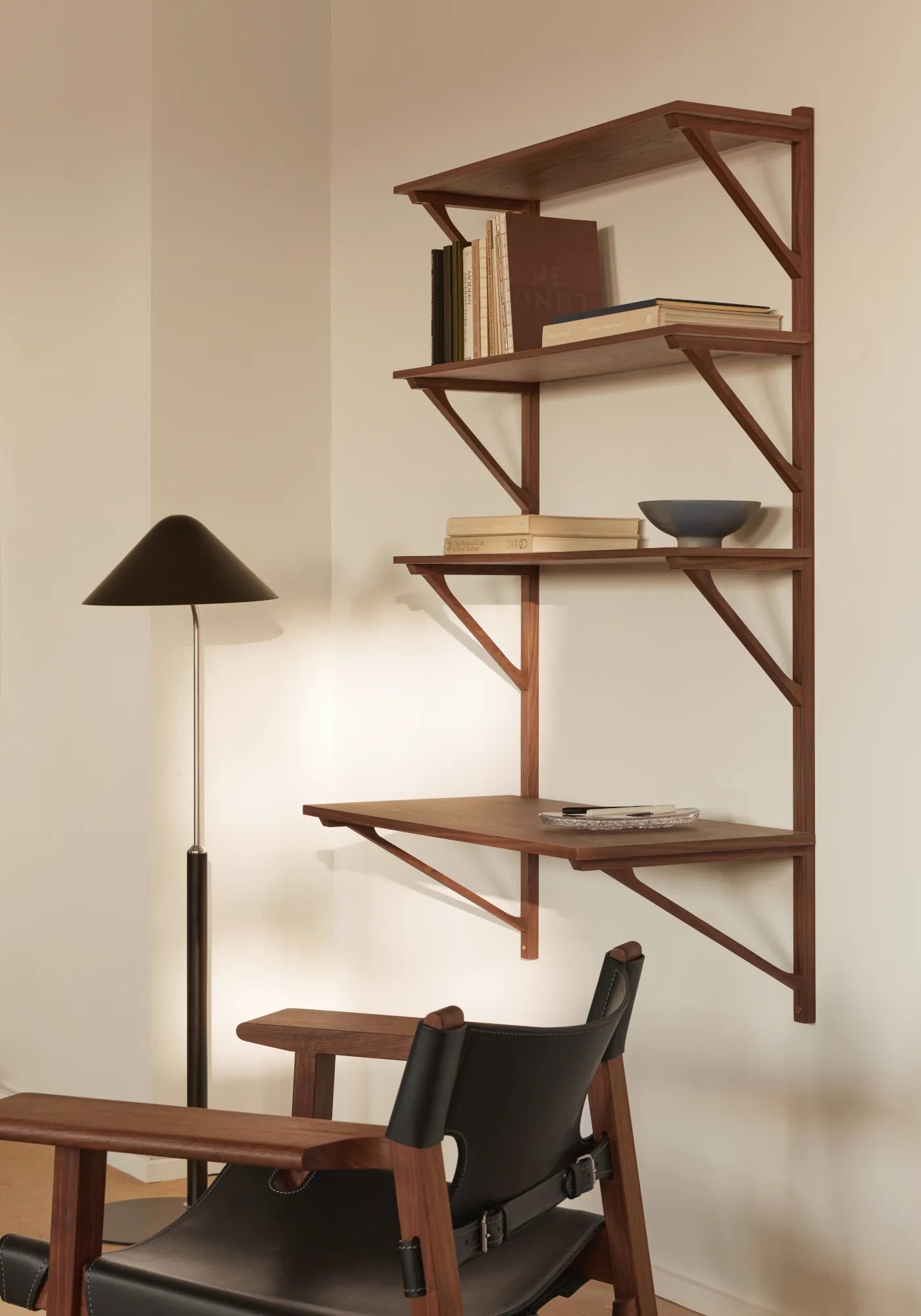 Wohnszene mit Holzregal, Lederstuhl und Stehleuchte im modernen skandinavischen Stil von Fredericia